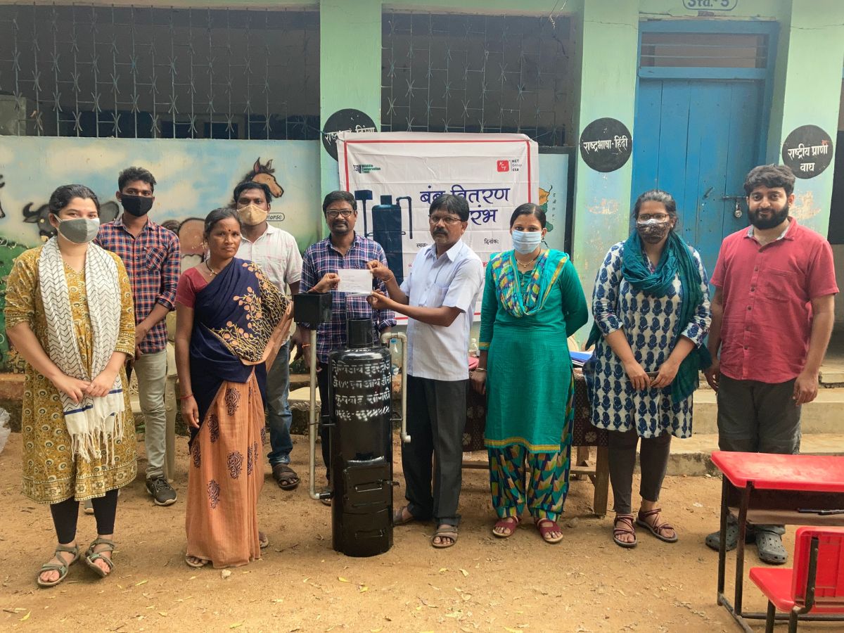 The thousandth beneficiary receives her water heater as the Conservation Behaviour team comes together for the distribution. Photo: WCT