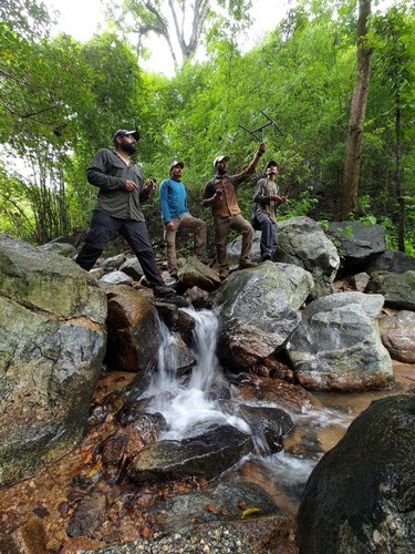 WCT research team monitoring a released pangolin in the field. Photo credit: WCT