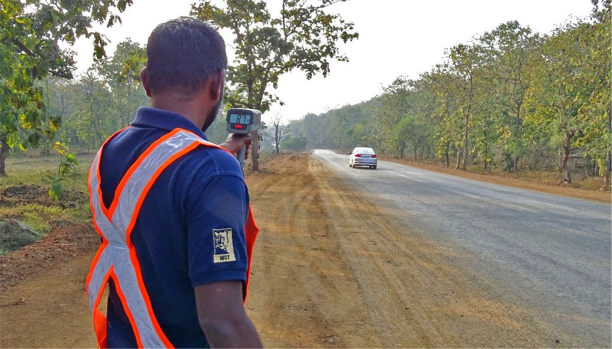 WCT team member collecting traffic speed data with a radar gun.